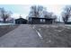 Newly renovated home with dark siding, detached garage, and a paved driveway at 1384 Cross St, Martinsville, IN 46151