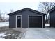 New detached garage with black door and raised panel garage door at 1384 Cross St, Martinsville, IN 46151