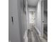 Clean hallway with grey walls and wood-look flooring, leading to bathroom and bedroom at 1384 Cross St, Martinsville, IN 46151