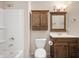 Clean bathroom with a shower/tub combo, wood vanity, and medicine cabinet at 1423 Chesterfield Dr, Anderson, IN 46012