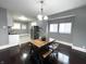 Dining area with dark hardwood floors and a rustic wooden table set at 1607 N Rural St, Indianapolis, IN 46218