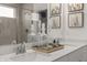 Bathroom featuring double sink vanity, framed mirror, decorative glass bottles and cactus themed prints at 19349 Sumrall Pl, Westfield, IN 46074