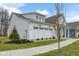 Bright white home featuring a two-car garage, manicured landscaping and a sidewalk at 19349 Sumrall Pl, Westfield, IN 46074