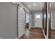 Hallway featuring paneled sliding doors with modern mirrors and wood flooring at 19349 Sumrall Pl, Westfield, IN 46074