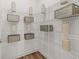 Well-organized pantry with white wire shelving and rustic decorative storage bins and pottery at 19349 Sumrall Pl, Westfield, IN 46074