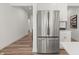Stainless steel refrigerator enhances this view of a modern kitchen with white cabinets and hardwood floors at 19349 Sumrall Pl, Westfield, IN 46074