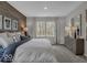 This main bedroom features beautiful wood accent wall, neutral colors, and large windows at 19365 Sumrall Pl, Westfield, IN 46074