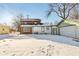 View of home's back and garage in winter at 202 W 3Rd St, Sheridan, IN 46069