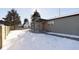 Gray house exterior showcasing a covered porch and a snow-covered yard at 240 E Caven St, Indianapolis, IN 46225