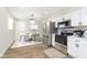 Open concept kitchen and dining area with stainless steel appliances and wood flooring at 240 E Caven St, Indianapolis, IN 46225