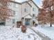 Two story condo building in winter with a blue door at 240 Legends Creek Pl # 104, Indianapolis, IN 46229