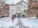 Two story condo building in winter with a blue door at 240 Legends Creek Pl # 104, Indianapolis, IN 46229