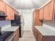 Galley kitchen with granite counters and wood cabinets at 240 Legends Creek Pl # 104, Indianapolis, IN 46229