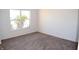 Bright bedroom with neutral-colored carpeting and a large window at 3246 Tupelo Dr, Indianapolis, IN 46239