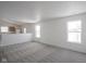 Spacious carpeted living room with two large windows, and adjoins a large eat-in kitchen at 3246 Tupelo Dr, Indianapolis, IN 46239