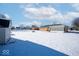 Snow-covered backyard with shed and neighboring homes at 3600 N Virginia Ave, Muncie, IN 47304