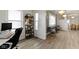 Bright home office with a wooden shelf next to an open view to the living room at 3838 Winthrop Ave, Indianapolis, IN 46205