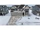 Two-story house with attached garage, snow covered yard, and a neighborhood view at 4061 Omaha Dr, Bargersville, IN 46106