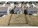 Aerial view of a spacious backyard with a black fence, surrounded by neighboring homes at 4061 Omaha Dr, Bargersville, IN 46106