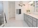 Bathroom with gray cabinets and a large vanity mirror at 4061 Omaha Dr, Bargersville, IN 46106