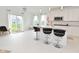 Well-lit kitchen with an island featuring bar seating, stainless steel appliances, and sliding glass doors to the backyard at 4061 Omaha Dr, Bargersville, IN 46106