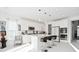 Modern white kitchen featuring an island with seating and double oven at 4061 Omaha Dr, Bargersville, IN 46106