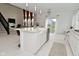 Modern kitchen with a spacious island, white cabinetry, granite counters and stainless steel appliances; open floorplan at 4061 Omaha Dr, Bargersville, IN 46106