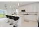 Modern kitchen with white cabinets, granite counters, island with bar stools, and stainless steel appliances at 4061 Omaha Dr, Bargersville, IN 46106