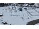 Aerial view of a snow covered playground with play equipment at 4061 Omaha Dr, Bargersville, IN 46106