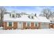 Charming brick home with dormer windows, attached garage, and snowy front yard at 4725 S Rural St, Indianapolis, IN 46227