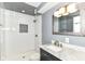 Beautiful bathroom featuring a tiled shower, modern vanity with marble countertop, and stylish lighting fixtures at 475 Golf Ln, Indianapolis, IN 46260