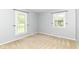 This bedroom boasts two large windows that flood the space with natural light, creating a serene and airy feel at 475 Golf Ln, Indianapolis, IN 46260