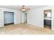 Bright bedroom featuring a ceiling fan, access to the bathroom, and closet that adds convenience to the space at 475 Golf Ln, Indianapolis, IN 46260