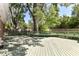 Outdoor deck with bench seating provides relaxation in private, shaded backyard at 475 Golf Ln, Indianapolis, IN 46260