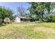 Backyard view of home with deck, shed, and spacious lawn at 475 Golf Ln, Indianapolis, IN 46260