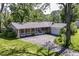 Charming single-story brick home featuring a covered front porch, attached garage, and a spacious front lawn at 475 Golf Ln, Indianapolis, IN 46260
