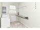 Well-lit laundry room with built in ironing board and shelving at 475 Golf Ln, Indianapolis, IN 46260