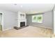 Spacious living room featuring a brick fireplace and large window at 475 Golf Ln, Indianapolis, IN 46260