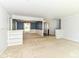 Open-concept living room with views into the dining room featuring blue accent wall and white wainscotting at 475 Golf Ln, Indianapolis, IN 46260