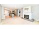 Open-concept living room with fireplace and adjacent kitchen with stainless steel appliances at 475 Golf Ln, Indianapolis, IN 46260