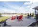 Relaxing backyard patio overlooking a pond with comfortable seating and string lights at 5328 Covington Ave, McCordsville, IN 46055
