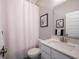 Clean bathroom with white vanity, shower/tub combo, and white curtain at 5328 Covington Ave, McCordsville, IN 46055