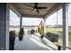 Covered patio with seating, a swing, and pond views at 5328 Covington Ave, McCordsville, IN 46055