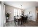 Elegant dining room with hardwood floors, chandelier, and farmhouse table at 5328 Covington Ave, McCordsville, IN 46055