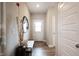 Bright entryway with tile flooring, bench, and mirror at 5328 Covington Ave, McCordsville, IN 46055