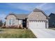Brick ranch home with attached two-car garage and manicured lawn at 5328 Covington Ave, McCordsville, IN 46055