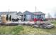 Gray house with a stone retaining wall and a large backyard patio at 5328 Covington Ave, McCordsville, IN 46055