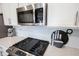 Stainless steel gas cooktop and microwave in a modern kitchen at 5328 Covington Ave, McCordsville, IN 46055