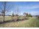 Landscaped area with trees and shrubs near pond at 5328 Covington Ave, McCordsville, IN 46055