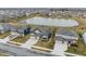 Aerial view of homes near a pond showcases the tranquil community setting at 5442 W Turnbuckle Pl, McCordsville, IN 46055